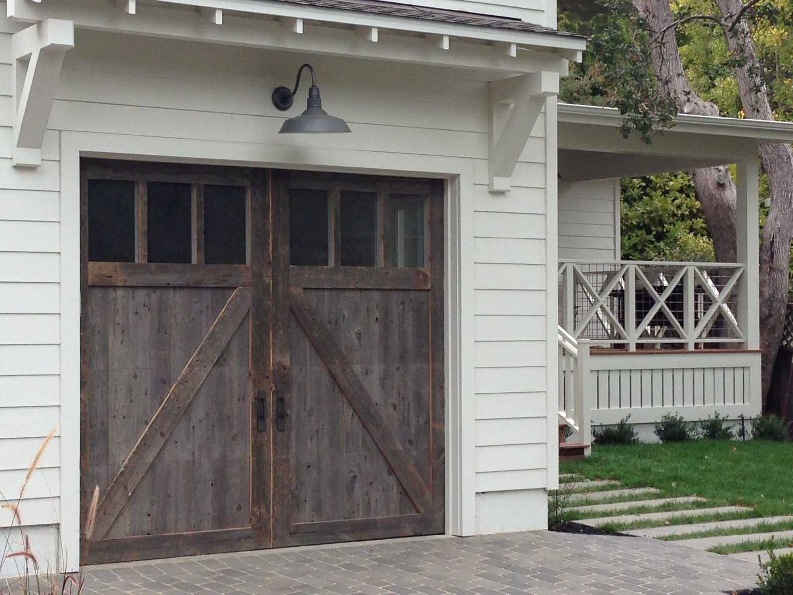 Custom-stained barn-style garage door installed.