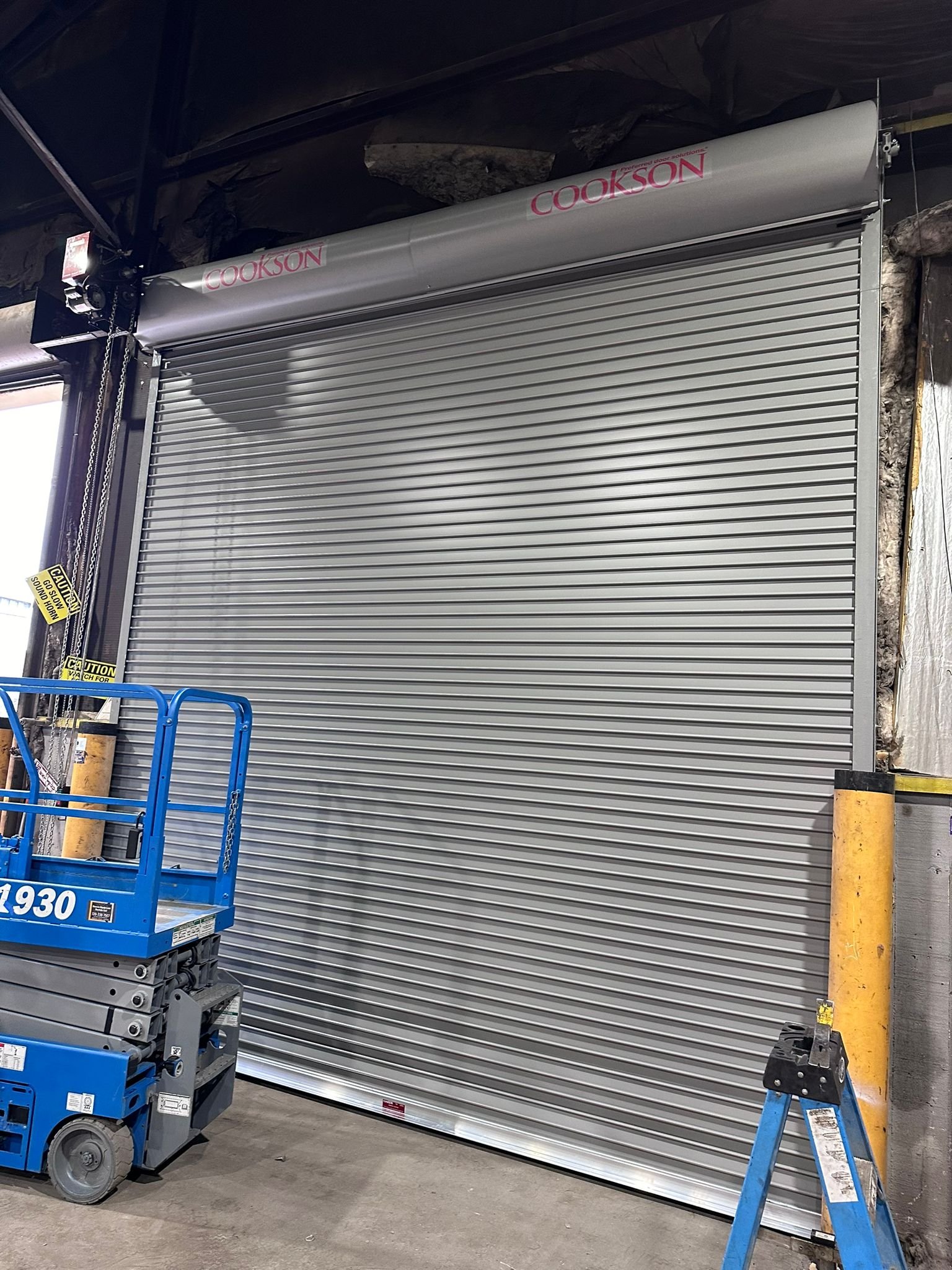 Rolling steel commercial garage door installation.