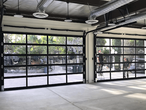 Full-view aluminum and glass garage door installed.