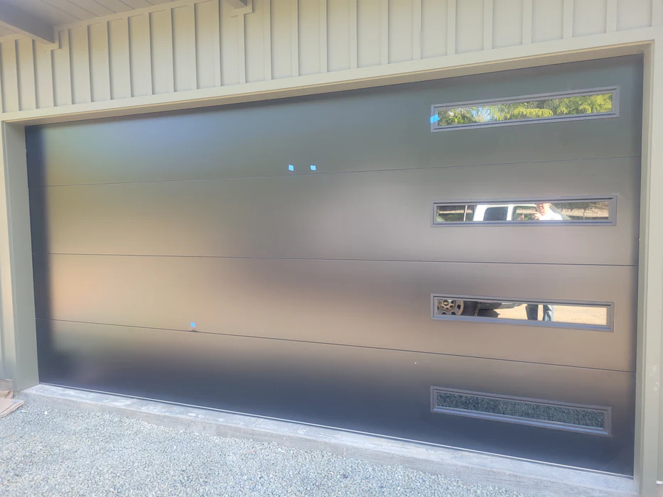 Modern flush-panel steel garage door installation.