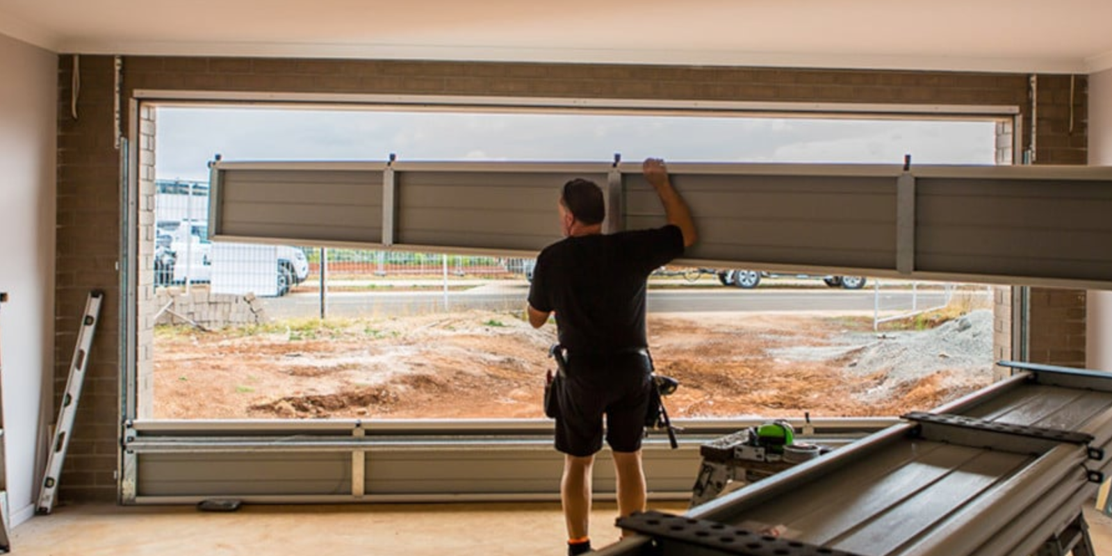 New three-car garage door installation for a new home.